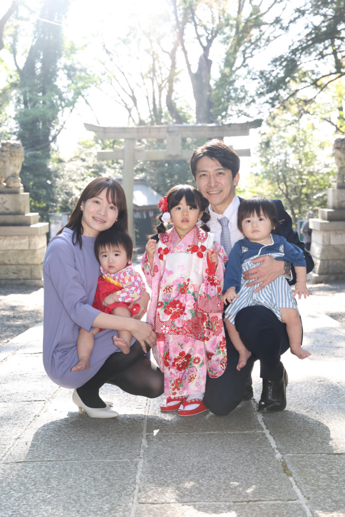 谷保天満宮の鳥居の前で撮影した家族5人の集合写真。子どもたちの自然な表情が印象的。